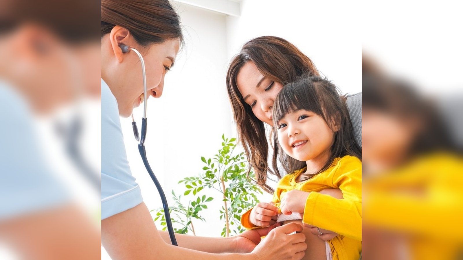 Pediatric nurse caring for a child at home with family nearby