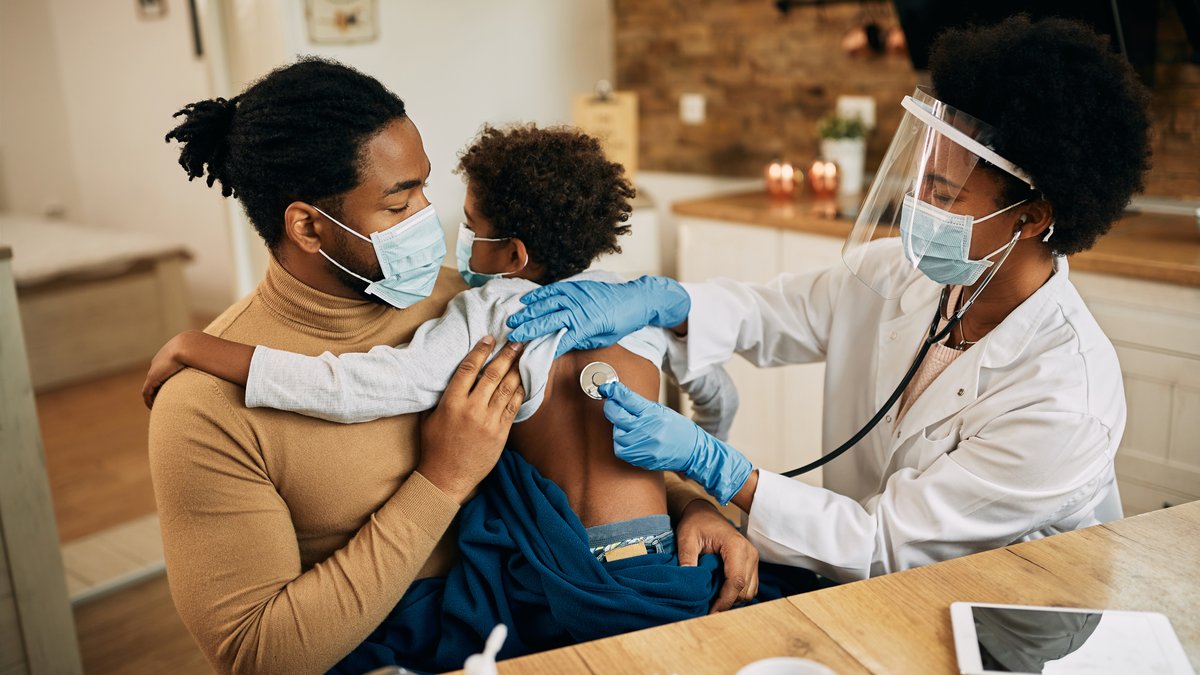 Caregiver and parent supporting a child at home